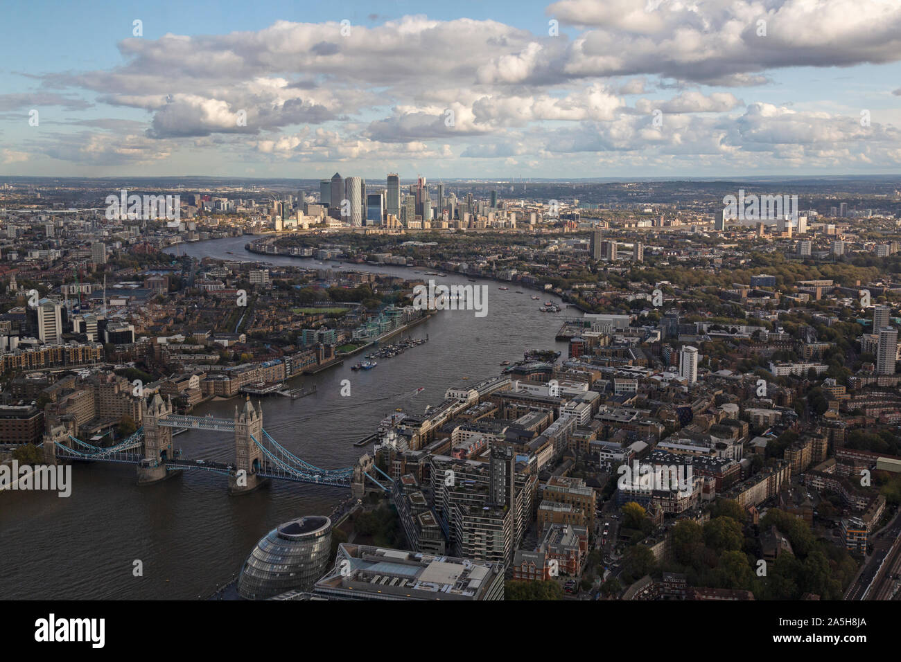 An aerial view looking East up the River Thames in London, from Tower Bridge up to Canary Wharf. Stock Photo