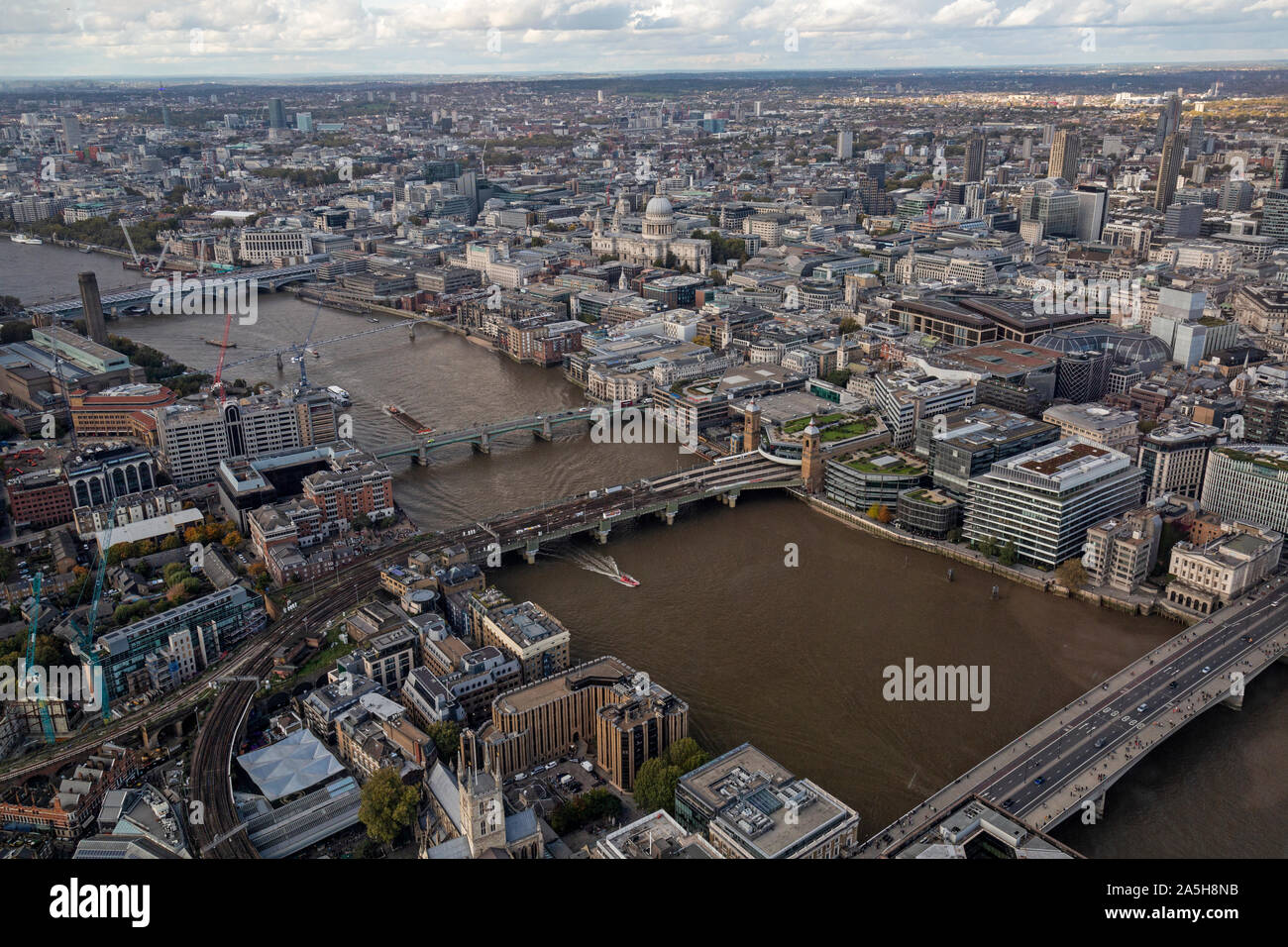 An aerial view looking down on the River Thames in London, with London Bridge, Southwark Bridge, Millennium Bridge, and Blackfriars Bridge. Stock Photo