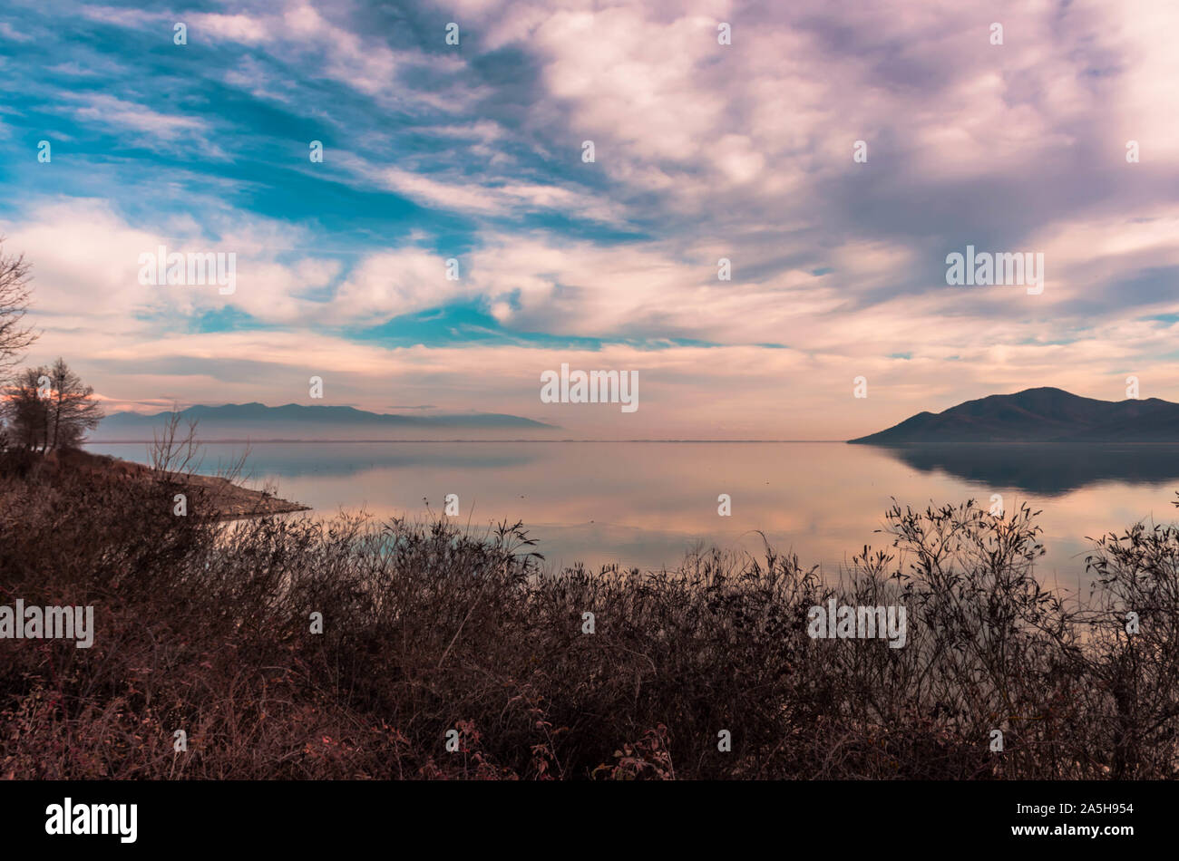 View of lake Kerkini and Beles mountain in Serres. Beautiful lake reflections at sunset time. Stock Photo