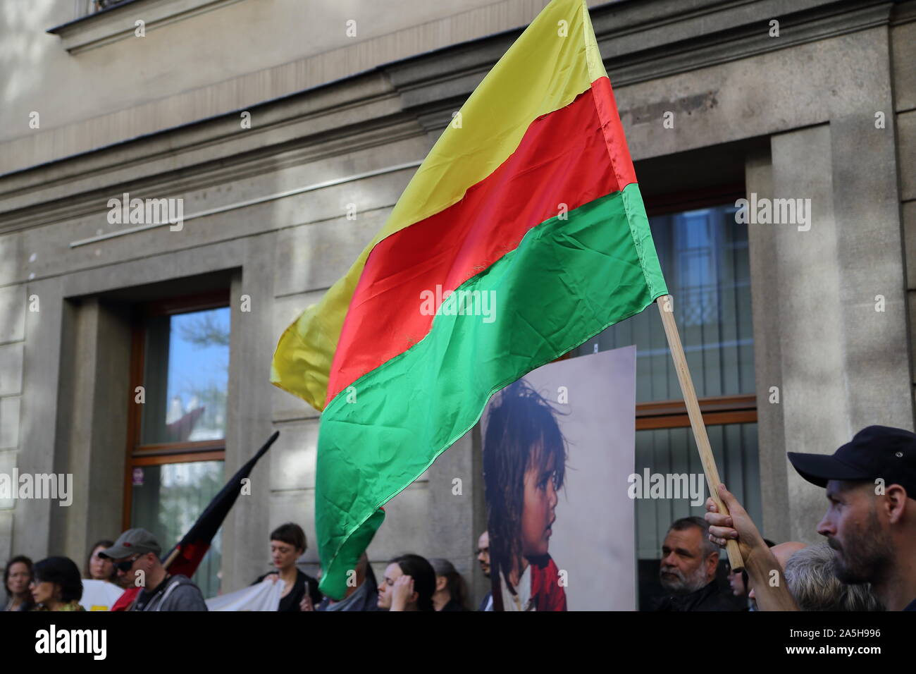 Local people in Krakow protest against Turksih invasion in Rojava / Northern Syria, with flag, photo of Kurdish child. Stock Photo