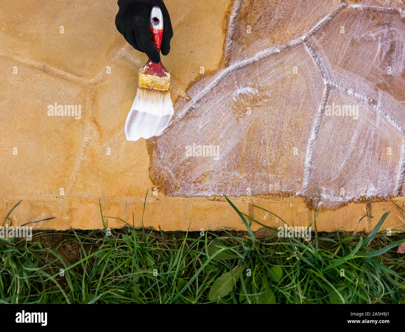 acrylic lacquer coating of yellow concrete tiles closeup Stock Photo