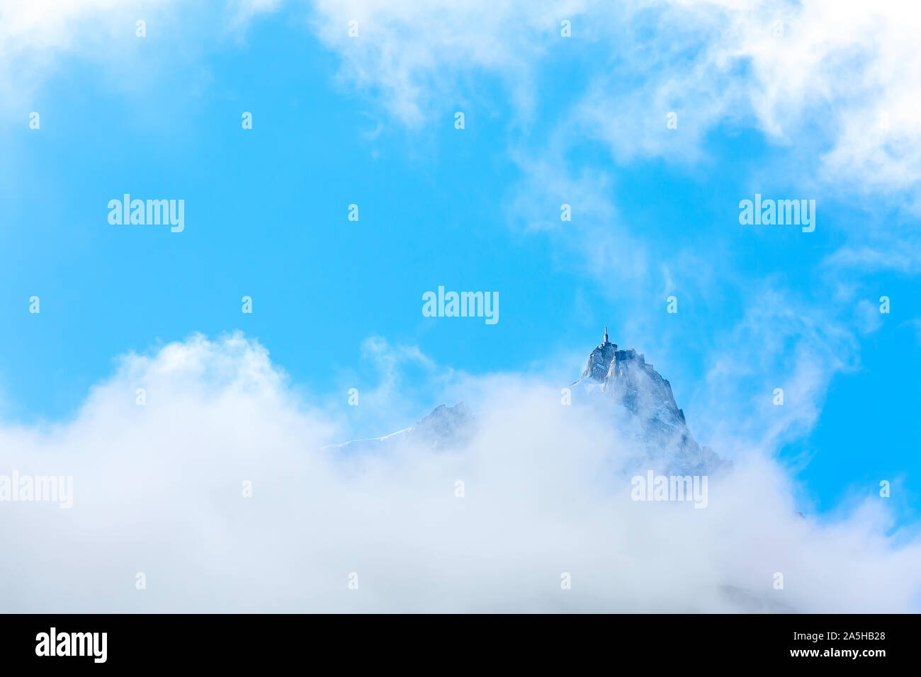 Aiguille du Midi peak between clouds, mountain in the Mont Blanc massif ...