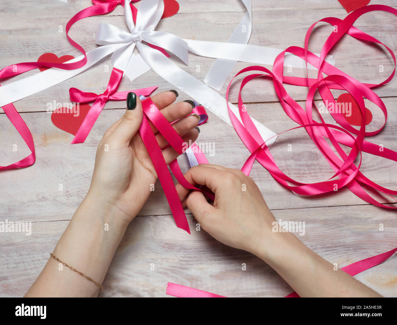 Pink, blue and white satin ribbon bows on wooden background. Scrapbooking  theme Stock Photo - Alamy