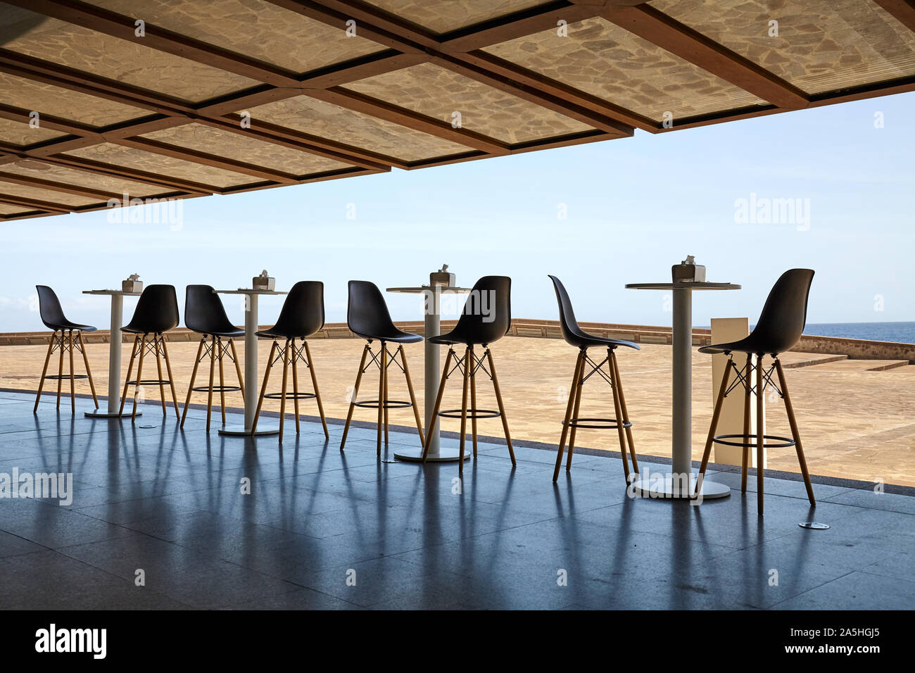 Empty tables and chairs with the seaside view. Stock Photo
