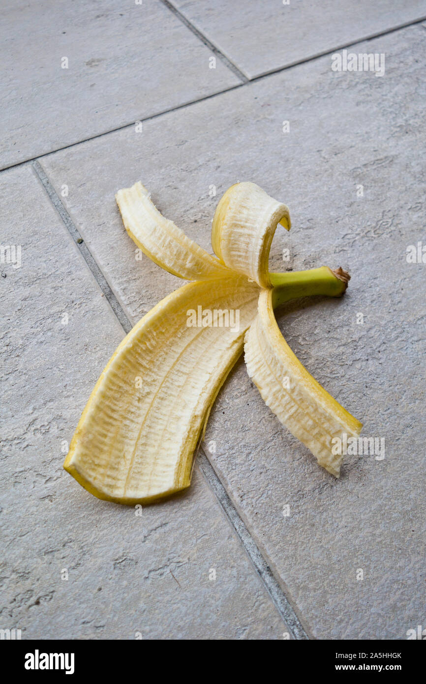 banana peel discarded on the floor Stock Photo