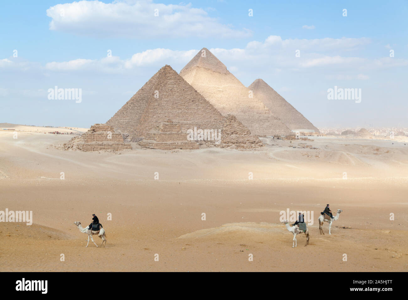 Egypt, Giza, the great Pyramids at Giza with men on camels. Stock Photo