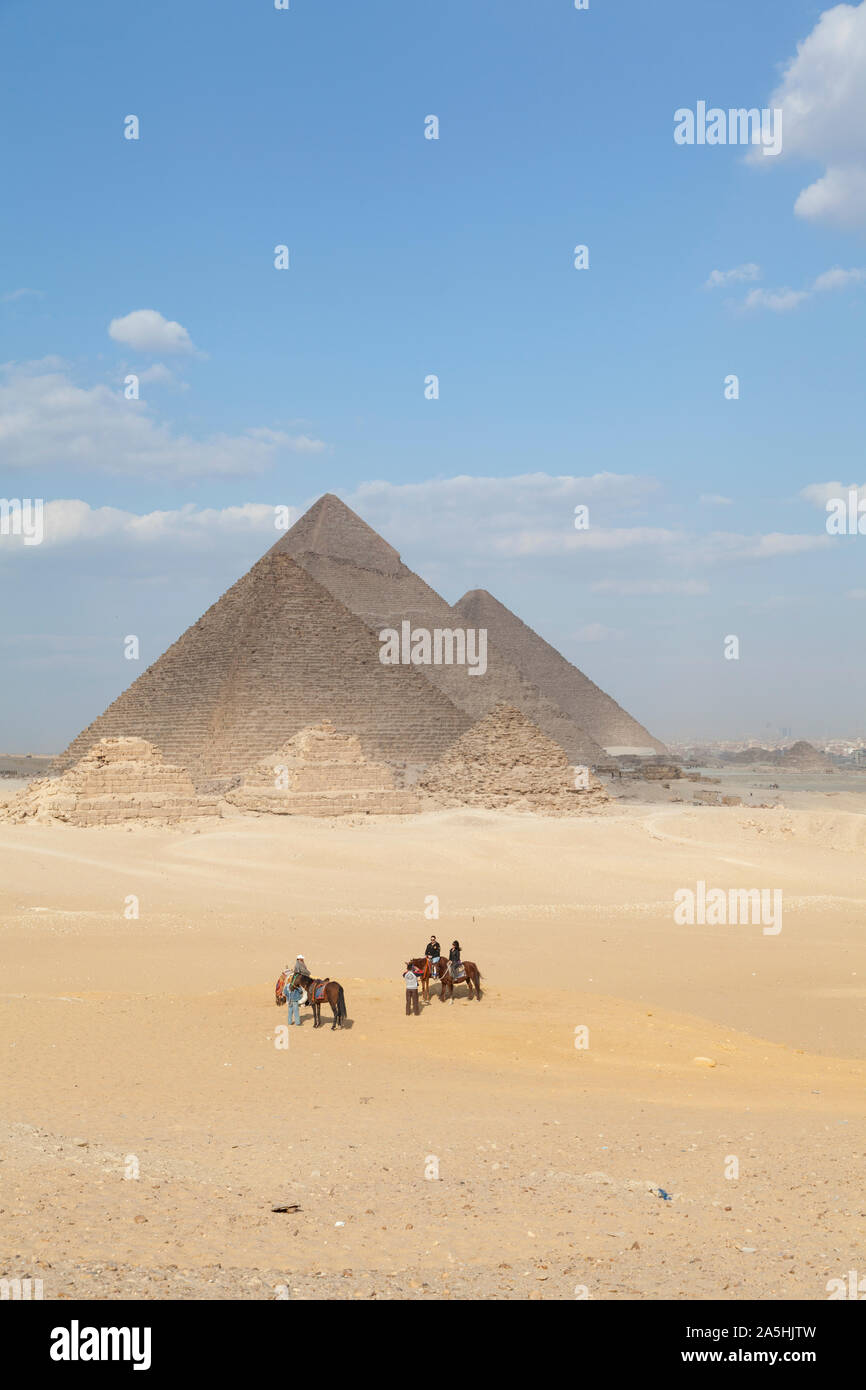 Egypt, Giza, the great Pyramids at Giza with tourists on horseback. Stock Photo