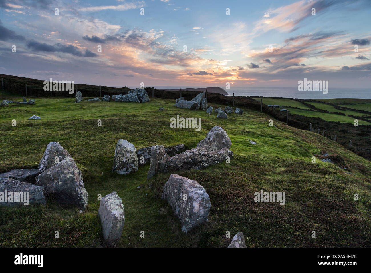 Meayll Circle chambered cairn and view towards the Calf of Man at sunset, Isle of Man Stock Photo