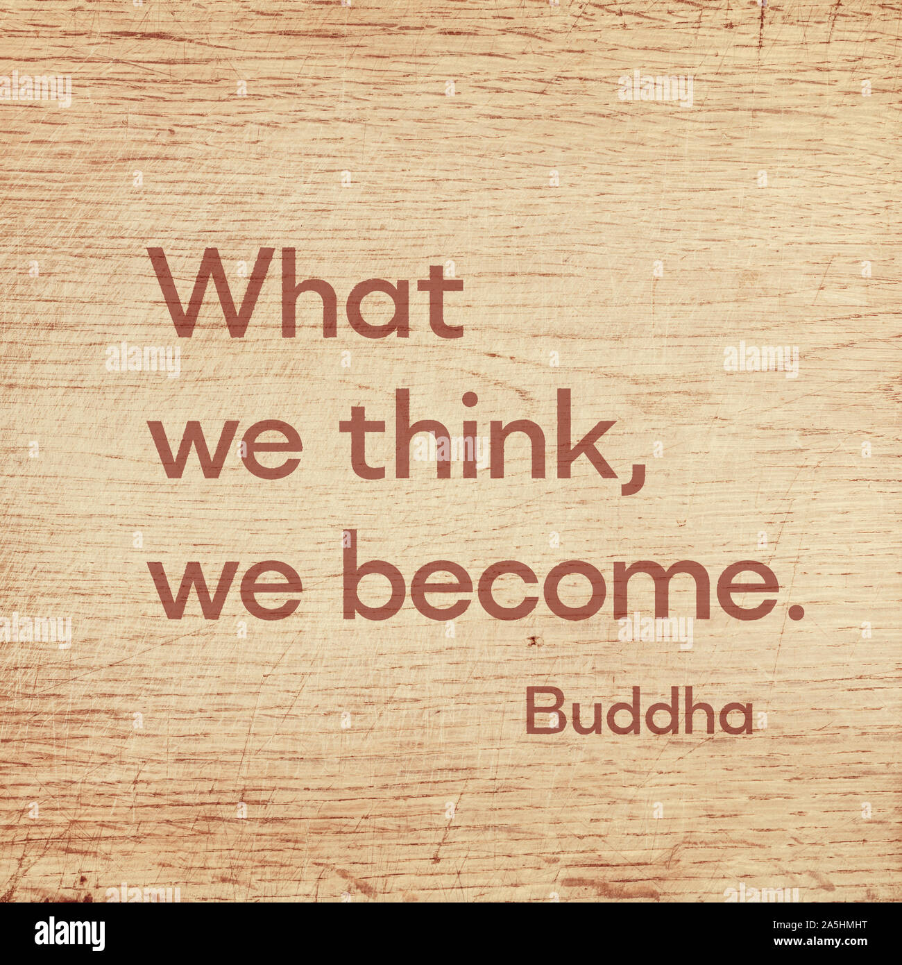 What we think, we become - famous quote of Gautama Buddha printed on grunge wooden board Stock Photo