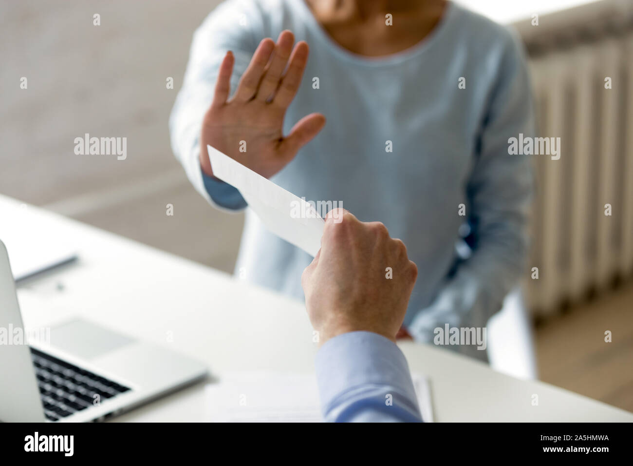 Honest company worker rejecting corrupting and bribery at workplace. Stock Photo