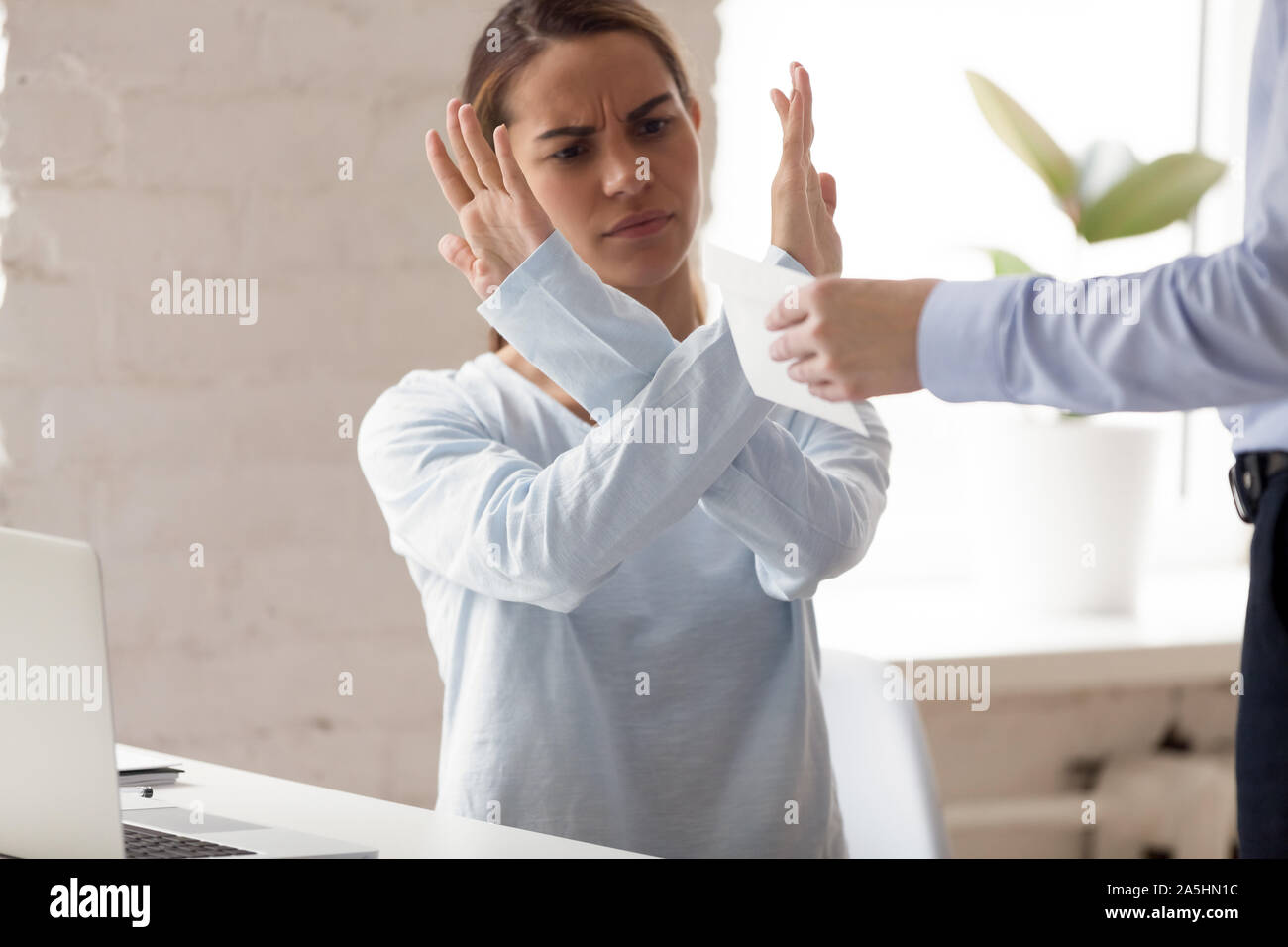 Angry millennial mixed race woman rejecting taking bribe. Stock Photo