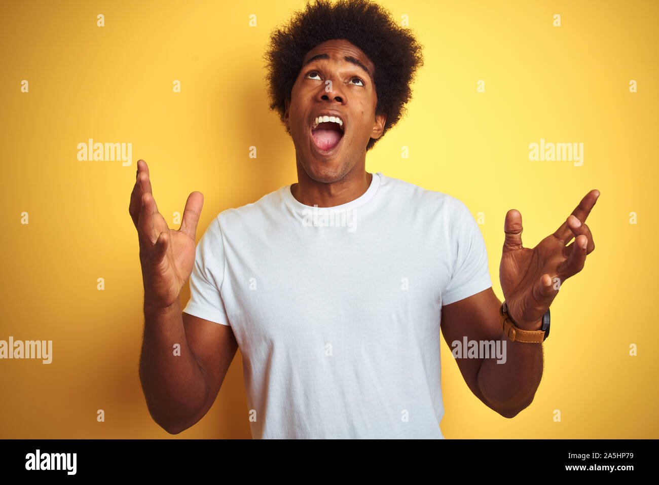 American Man With Afro Hair Wearing White T Shirt Standing Over