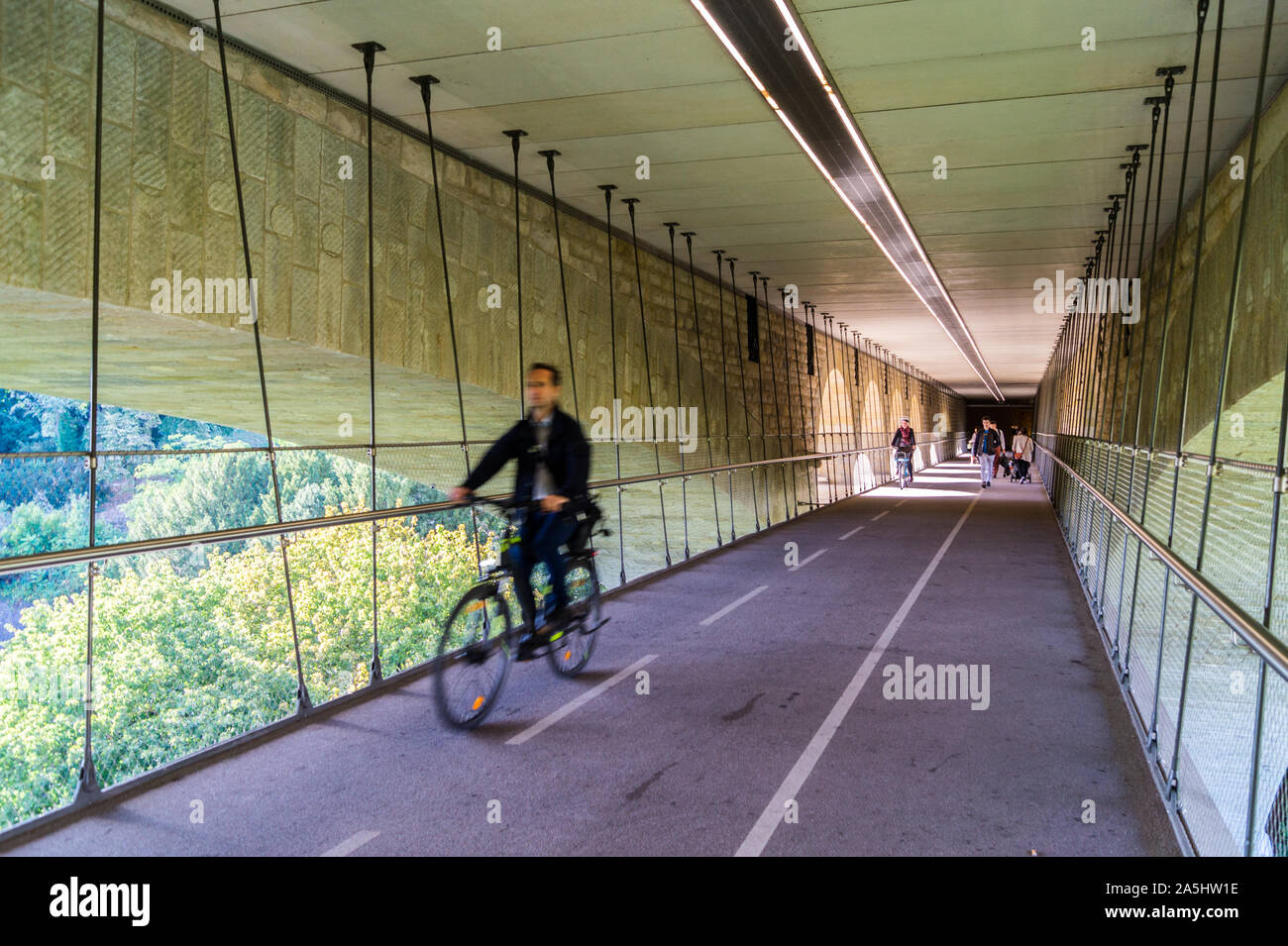 Male cyclist on the cycle path suspended under Pont Adolphe, Adolphe Bridge, Luxembourg city, Grand Duchy of Luxembourg Stock Photo