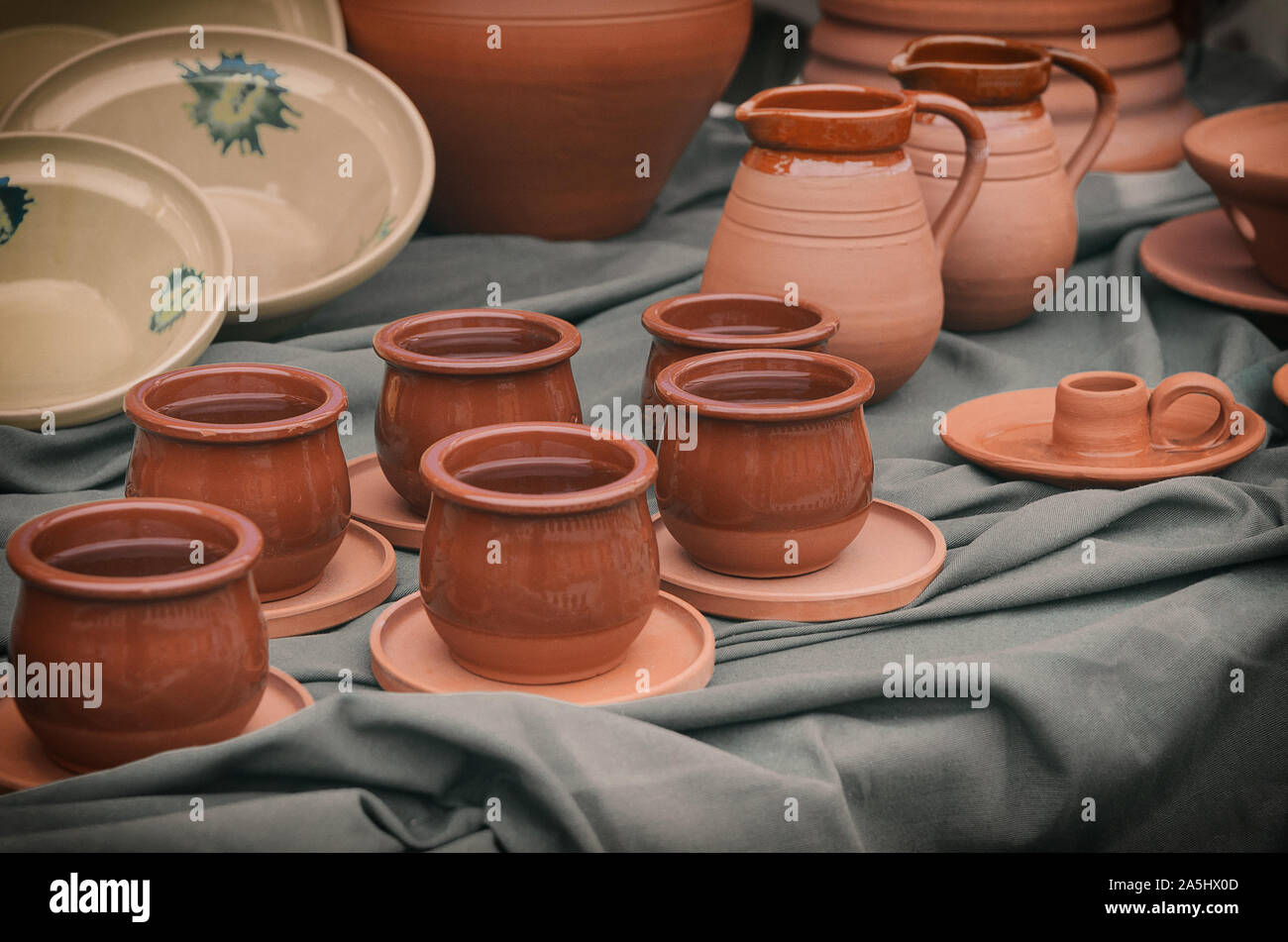 Clay pottery background. Handcrafts potter ceramics: pots, pitchers, cups,bowls  on table. Artisan art concept. Stock Photo