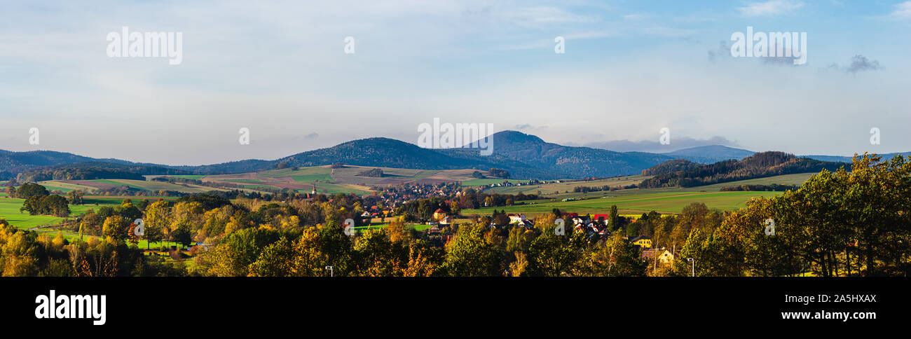 panoramic autumn view on Lusatian Mountains with the villages Hoernitz and Bertsdorf in the foreground and Mount Lausche in the background as seen fro Stock Photo