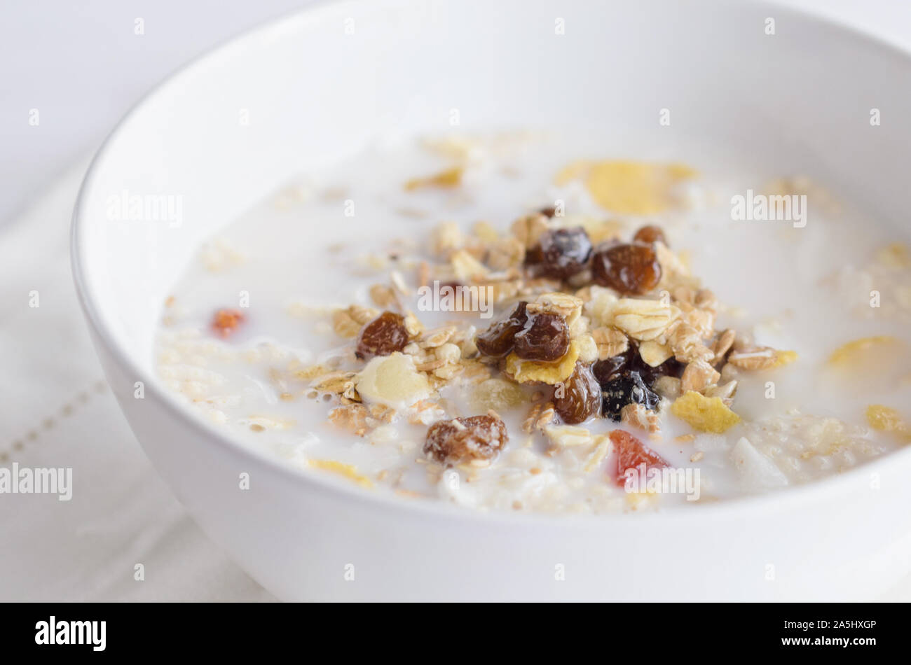 Muesli  bowl with  mix of unprocessed whole grains, nuts, seeds, fruit and vegan milk. Delicious breakfast meal for  energize your day. Heathy food li Stock Photo