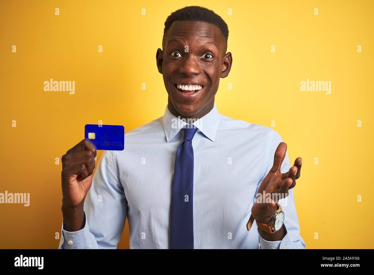 African american businessman holding credit card standing over isolated ...