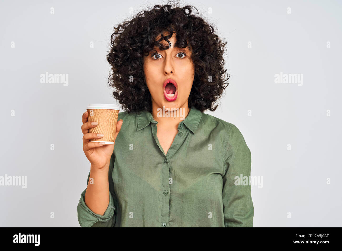 Young Arab Woman With Curly Hair Drinking Cup Of Coffee Over