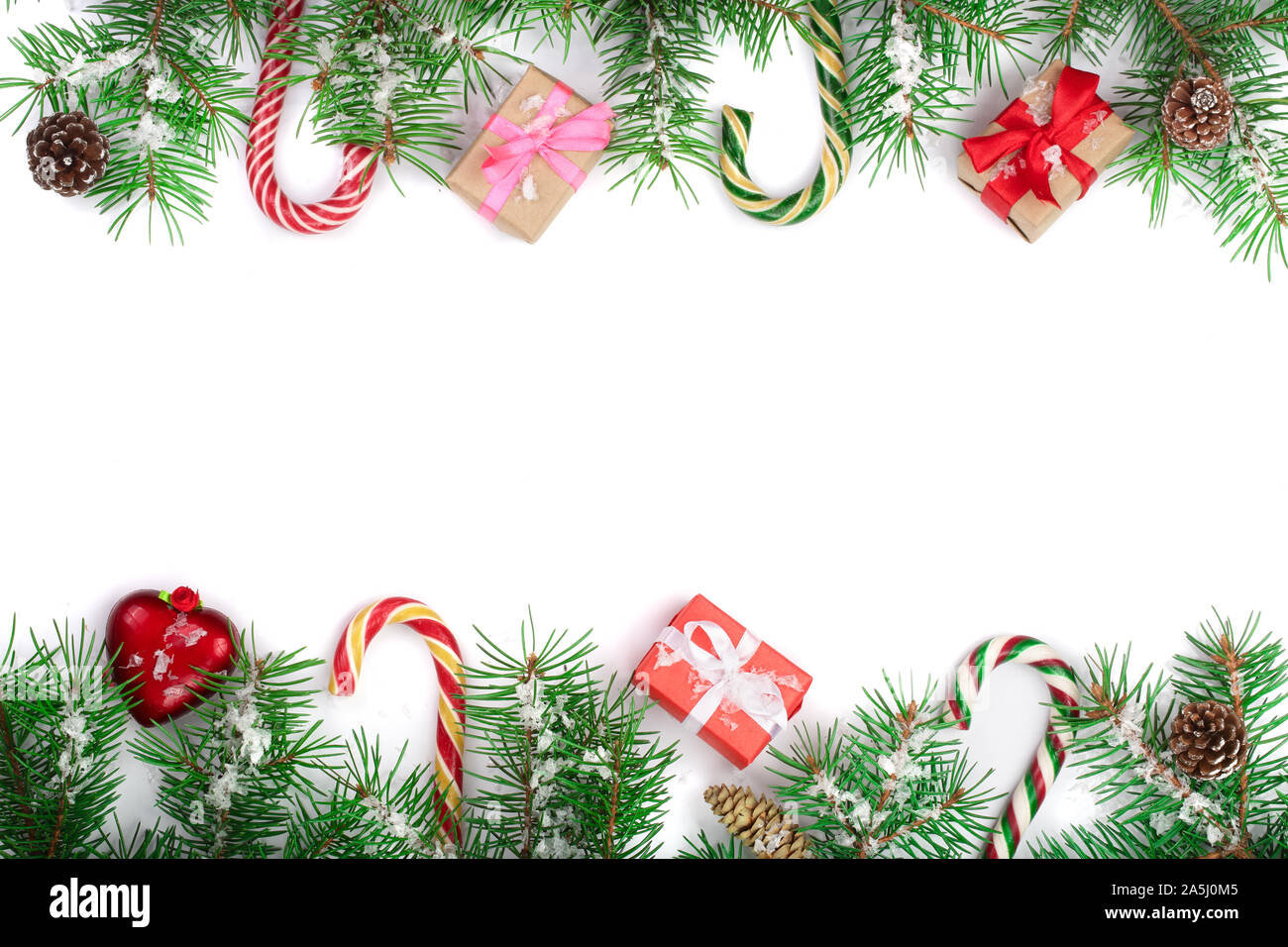 Christmas Frame of Fir tree branch with candy canes and boxes isolated ...