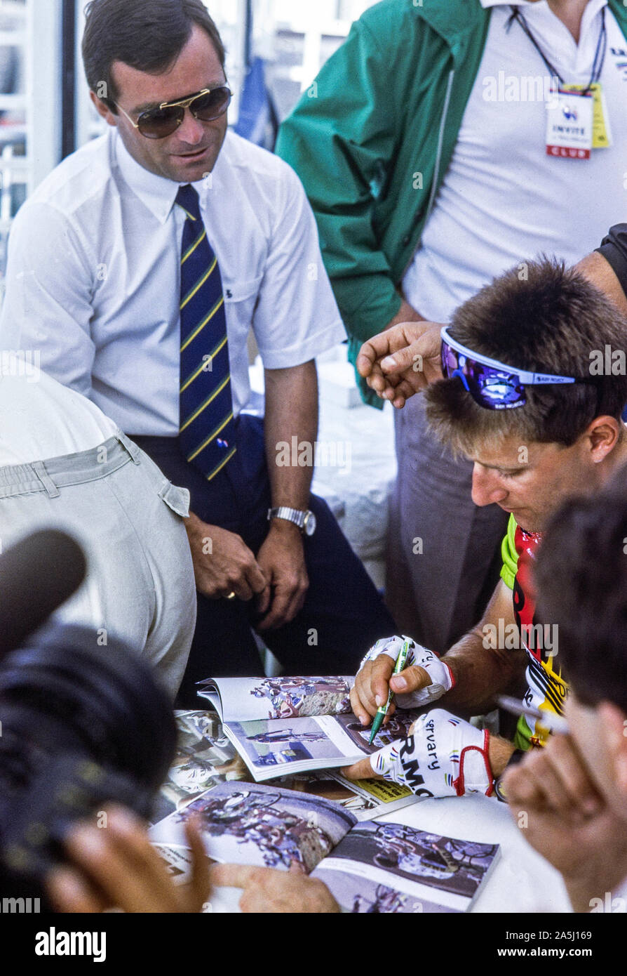 Charly Mottet (RMO) signong autograph  under the watchfull eyes of Bernard Hinault Stock Photo