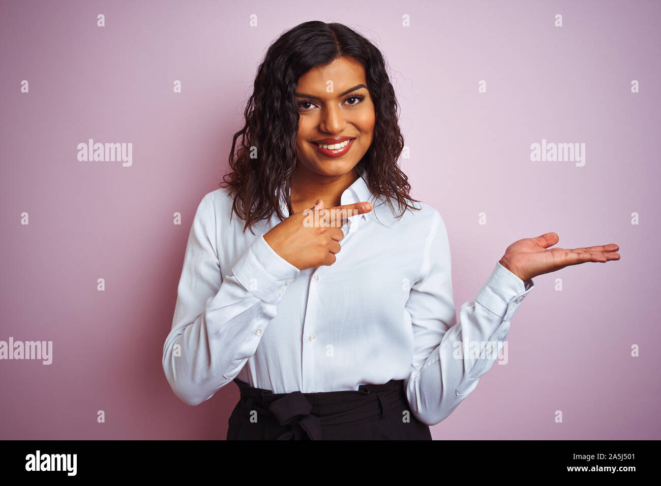 Beautiful transsexual transgender elegant businesswoman over isolated pink  background amazed and smiling to the camera while presenting with hand and  Stock Photo - Alamy