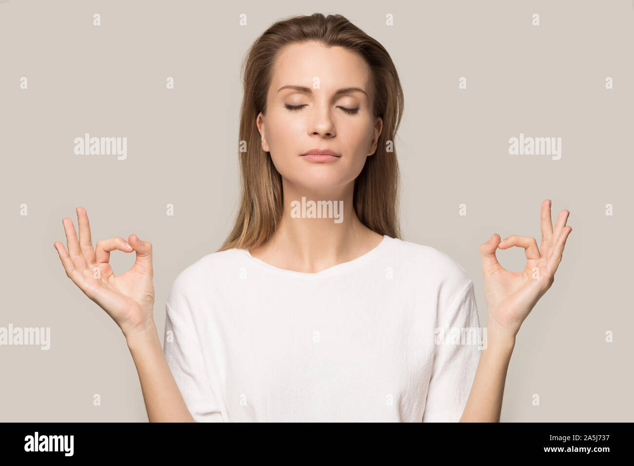 Calm young woman meditate with eyes closed Stock Photo - Alamy