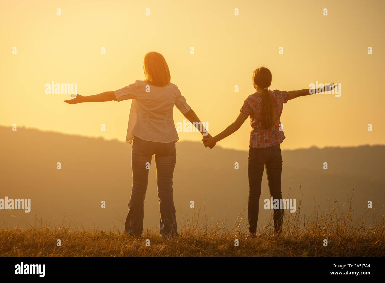 Happy grandmother and granddaughter enjoying sunset Stock Photo - Alamy