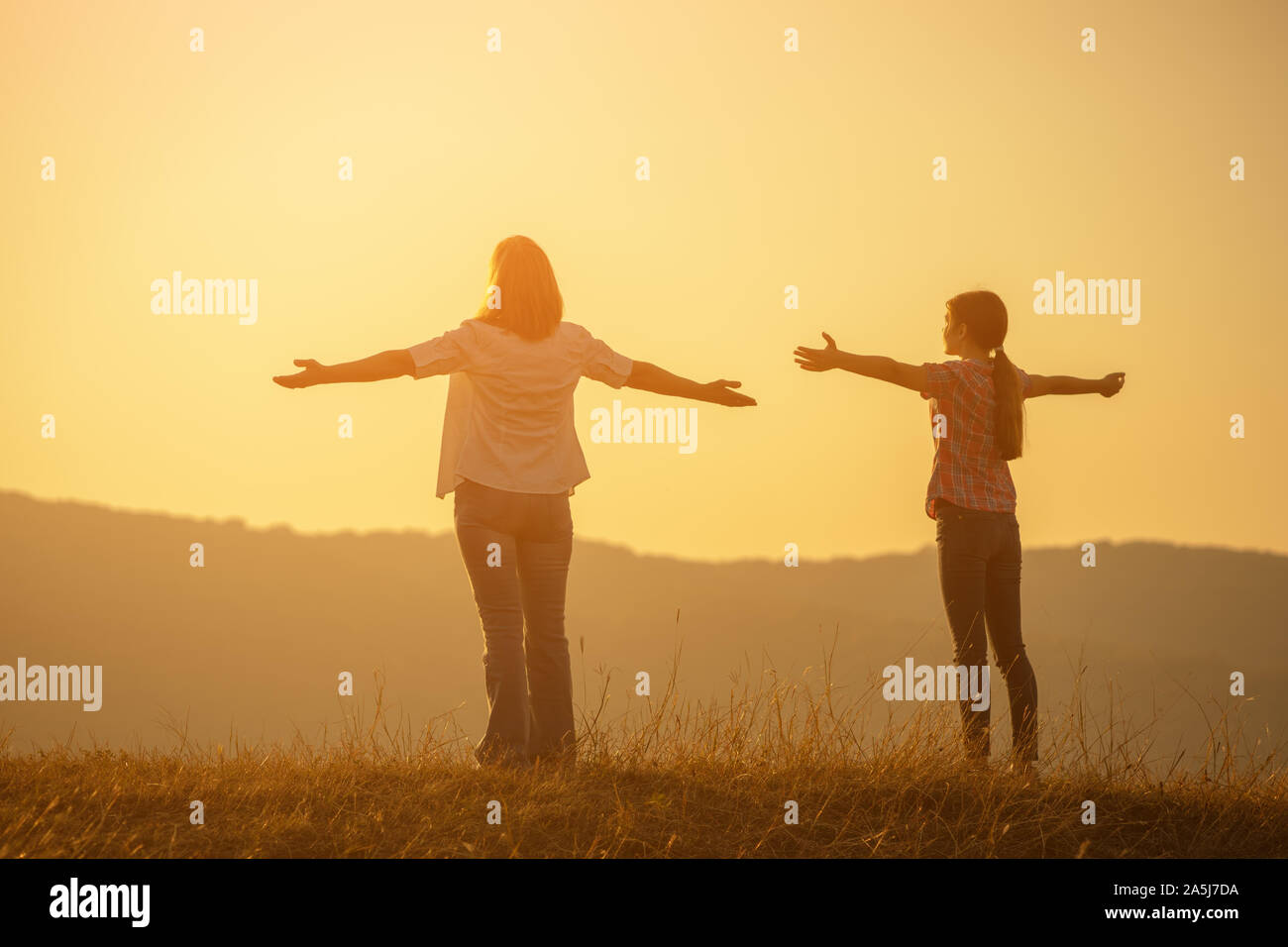 Happy grandmother and granddaughter enjoying sunset Stock Photo - Alamy