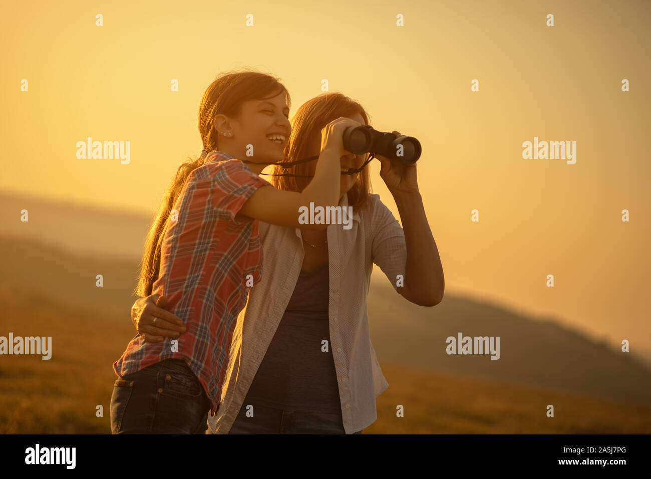 Happy grandmother and granddaughter enjoying nature and sunset Stock ...