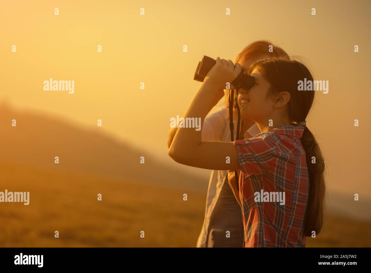 Happy grandmother and granddaughter enjoying nature and sunset Stock ...