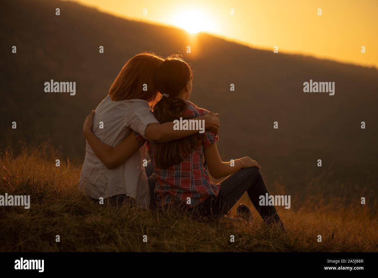 Happy grandmother and granddaughter enjoying nature and sunset Stock ...