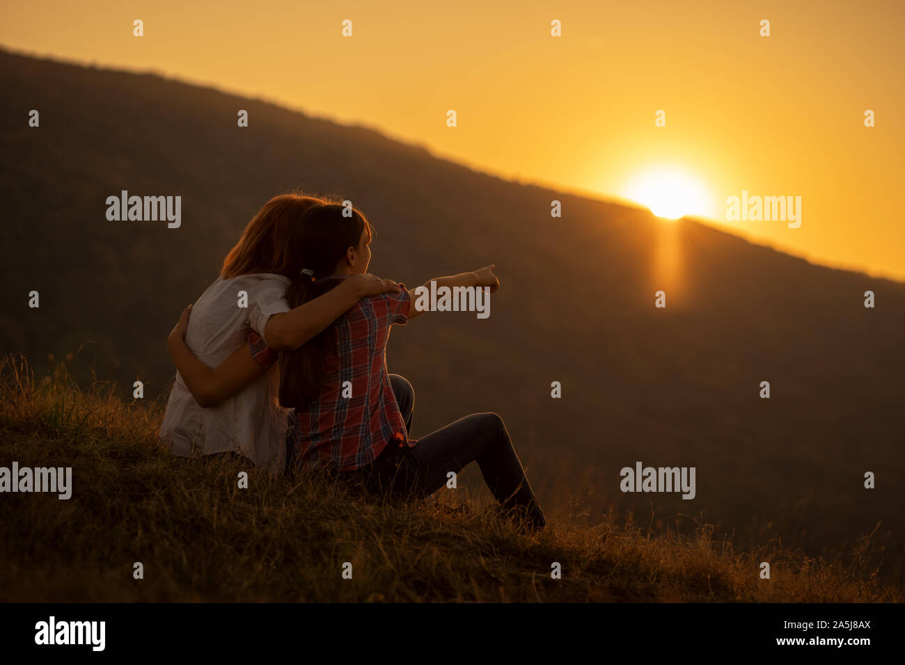 Happy grandmother and granddaughter enjoying nature and sunset Stock ...