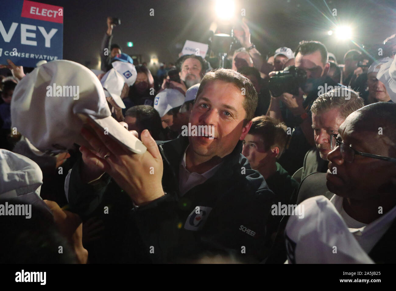 Richmond, Canada. 21st Oct, 2019. Canadian Conservative Party leader Andrew Scheer autographs hats with the Conservative logo for constituents at a rally in Richmond, British Columbia, October 20, 2019 during the last day of federal election campaigning. Election day is tomorrow, October 21, 2019. Photo by Heinz Ruckemann/UPI Credit: UPI/Alamy Live News Stock Photo