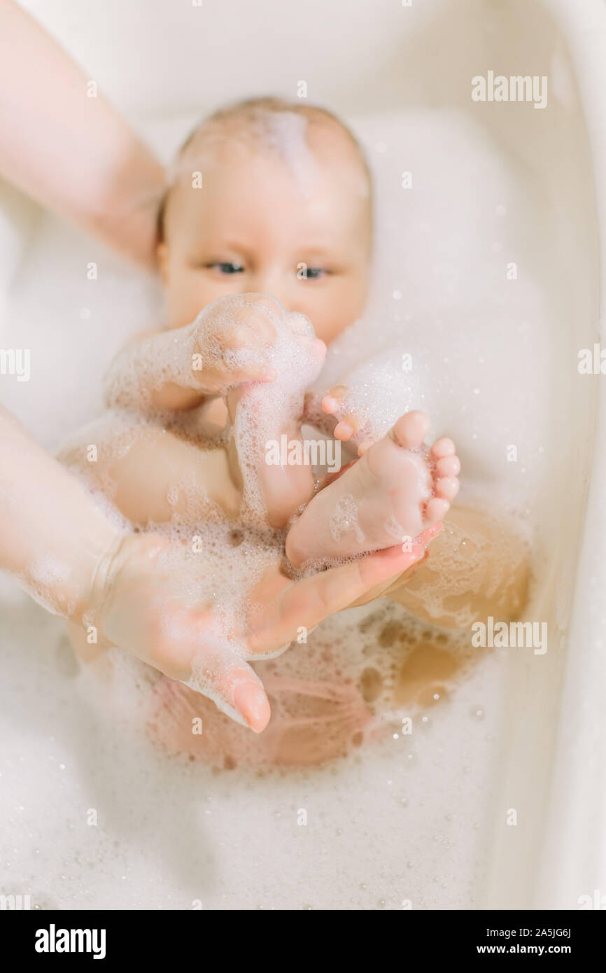 Happy little baby a swimming in the bathroom.Portrait of baby bathing