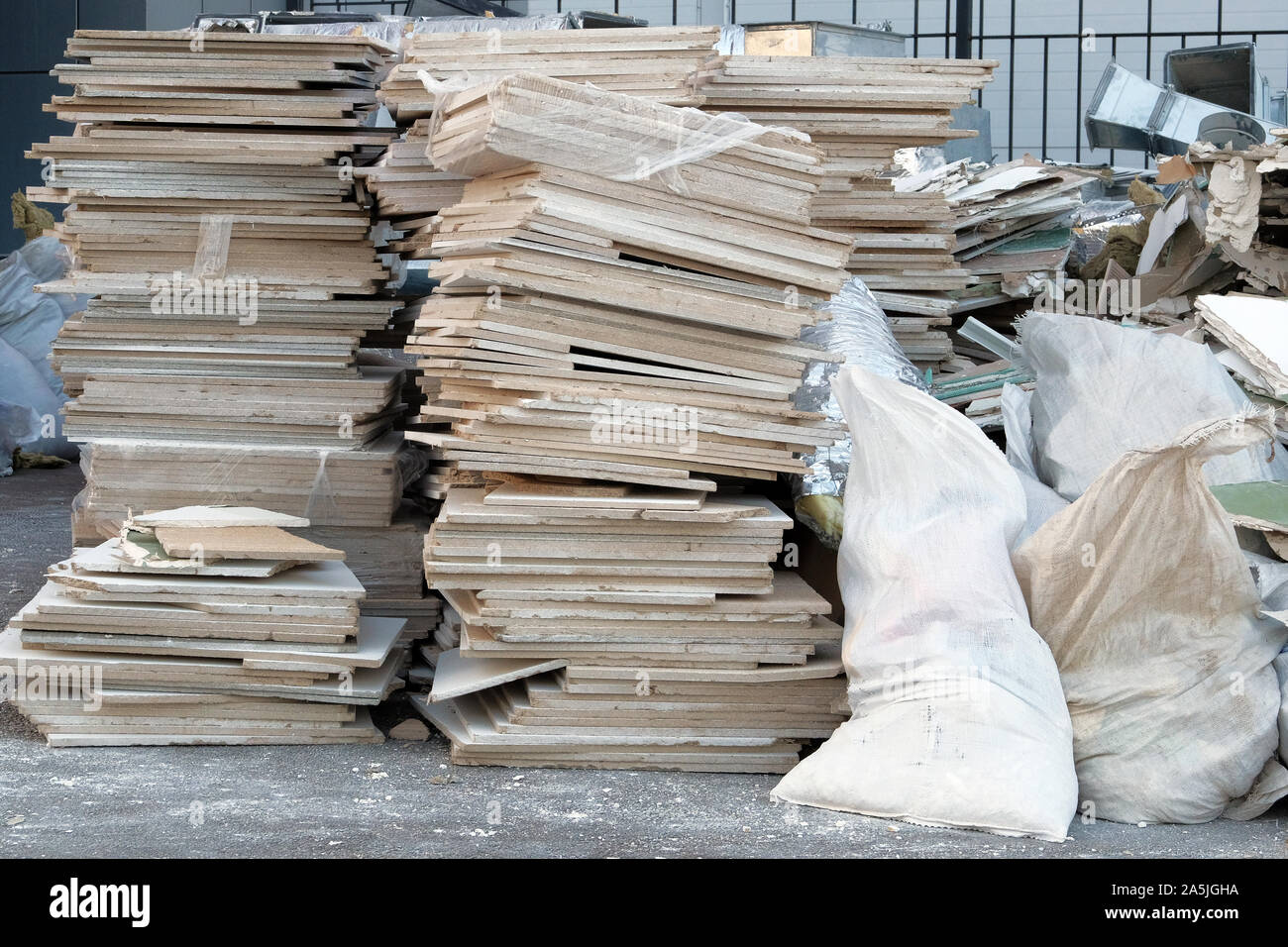Construction debris in white bags prepared for disposal in a landfill