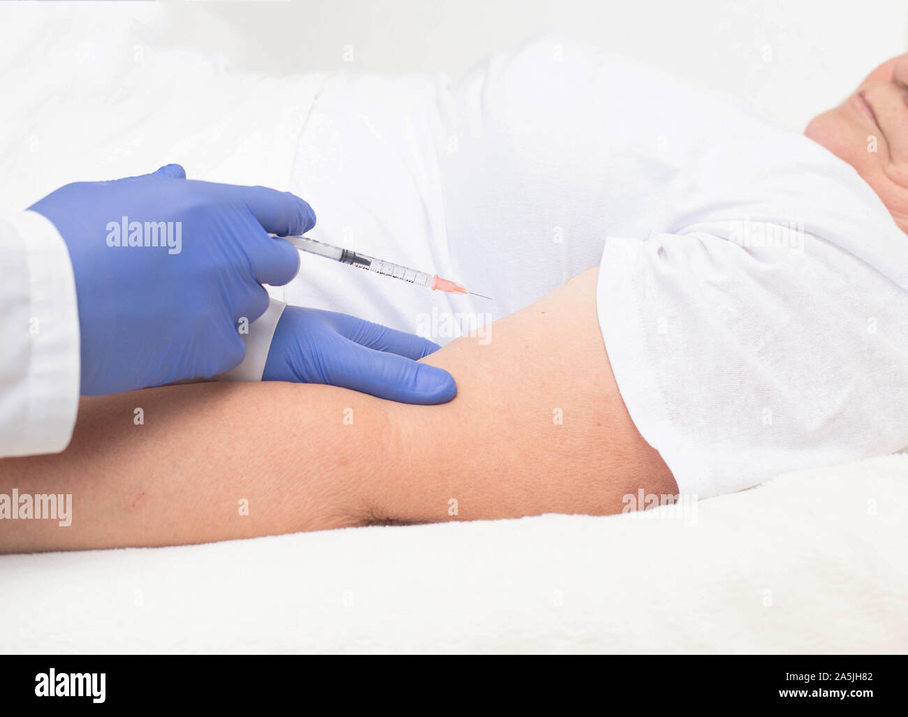 Specialist doctor injects insulin to an elderly woman with diabetes ...