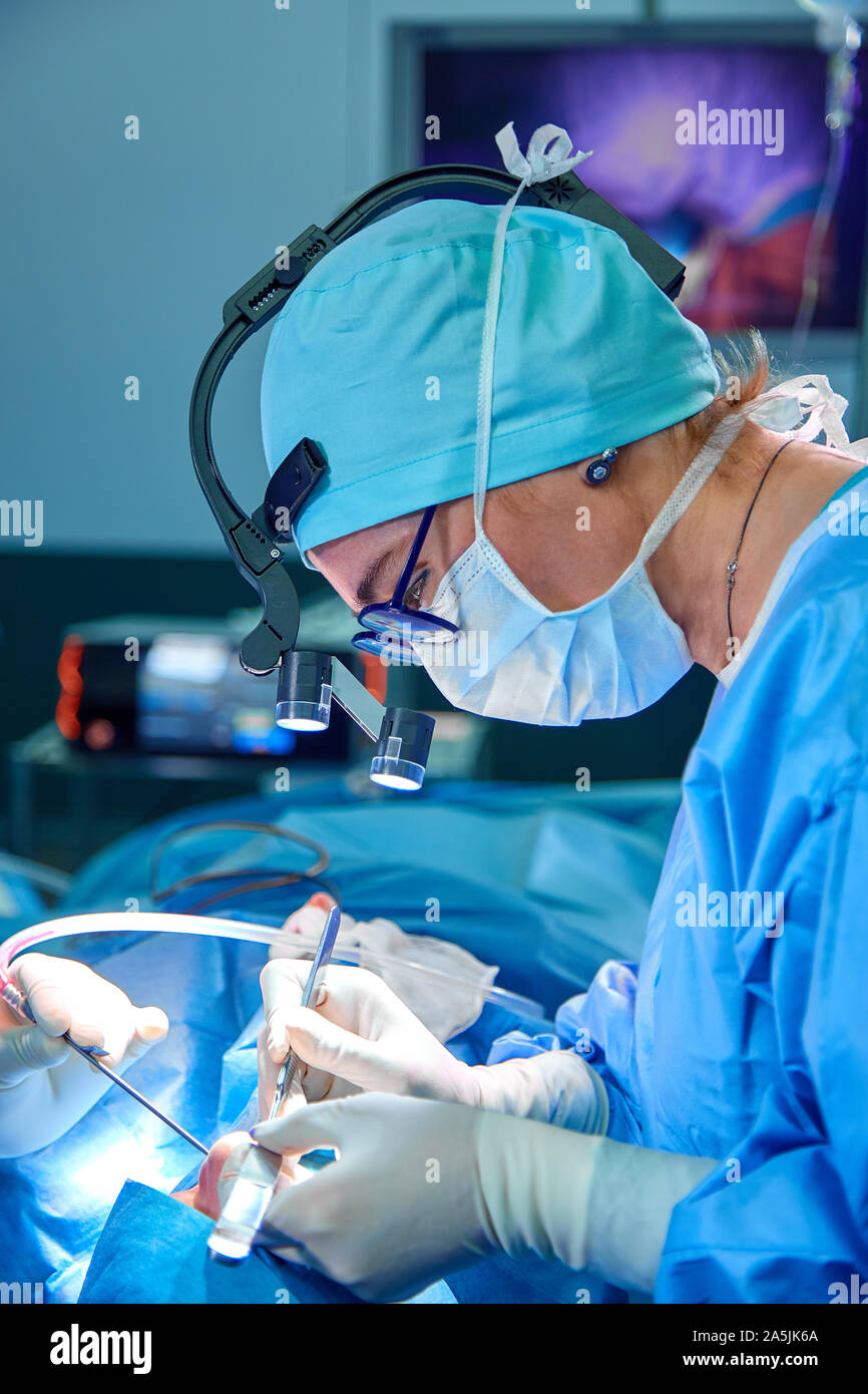 Close up portrait of female surgeon doctor wearing protective mask and ...