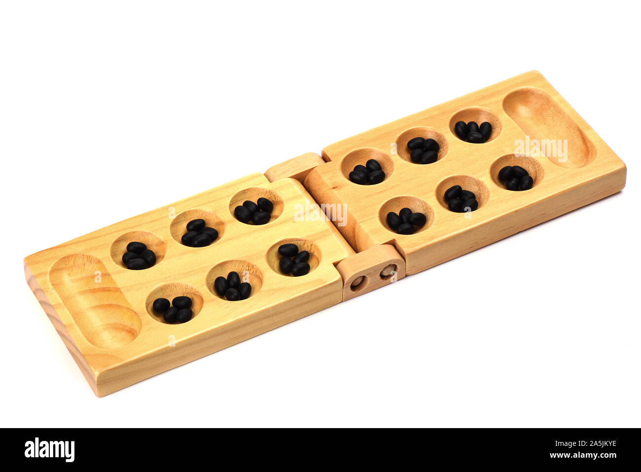 Stones and wooden folding board for playing mancala. Hole stones, the starting position of the game. The concept of board games. Stock Photo