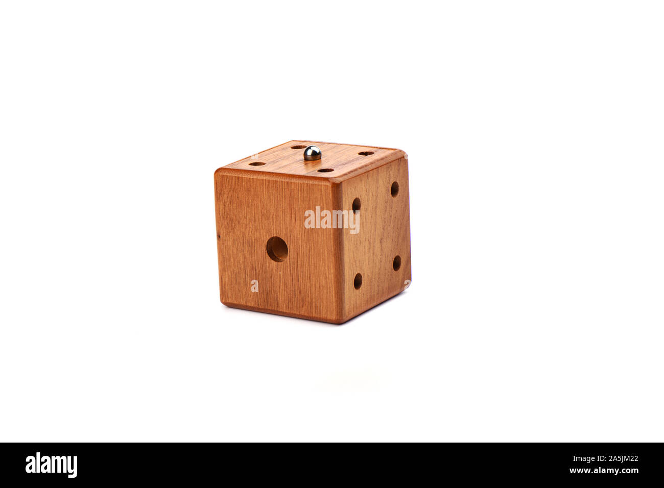 Puzzle magic cube three-dimensional maze. Wooden cube with a metal ball on a white background. Puzzle concept. Copy space. Stock Photo