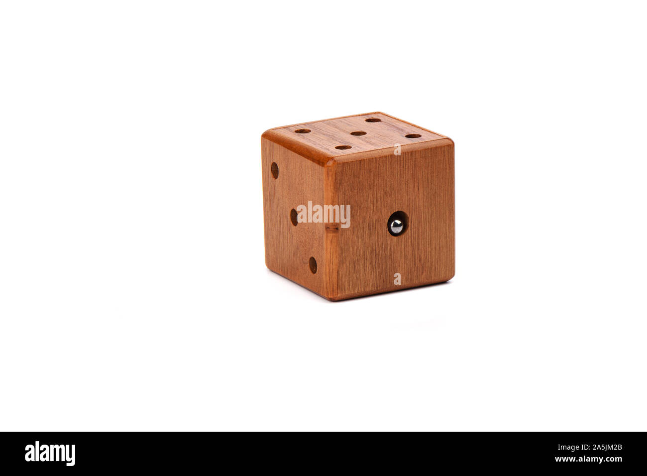 Puzzle magic cube three-dimensional maze. Wooden cube with a metal ball on a white background. Puzzle concept. Copy space. Stock Photo