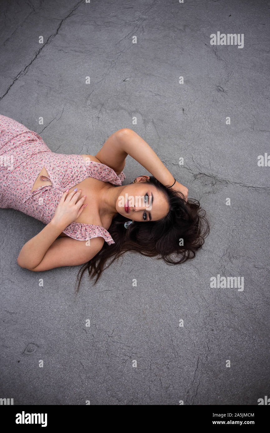 Ciara, lying down, pink dress, 2019 Stock Photo