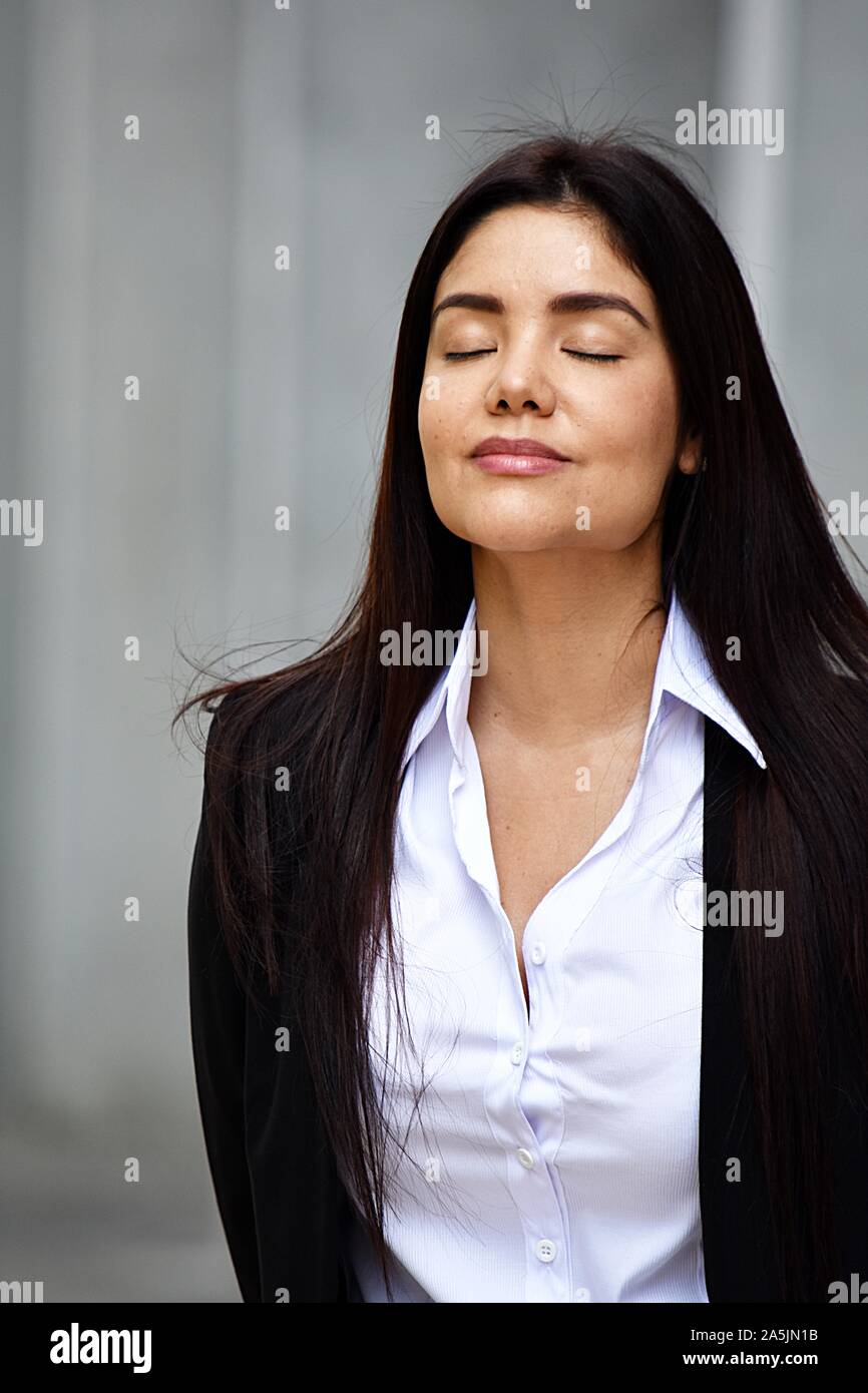 Latino Business Woman Meditating Wearing Suit Stock Photo - Alamy