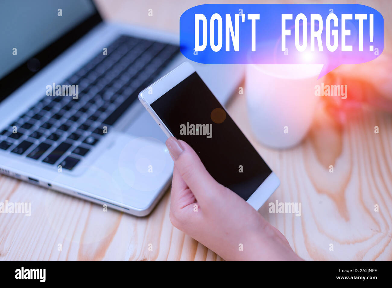 Text sign showing Don T Forget. Business photo showcasing used to remind someone about important fact or detail woman laptop computer smartphone mug o Stock Photo