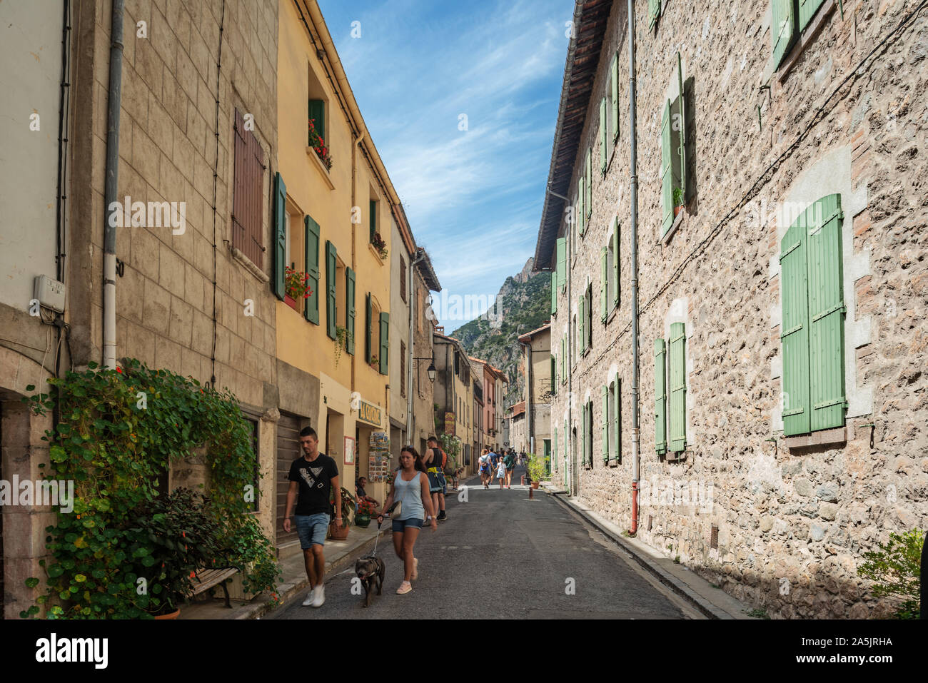 People walking in old streets of Villefranche-De-Conflent town, Pyrenees Orientales, French Catalonia, France Stock Photo
