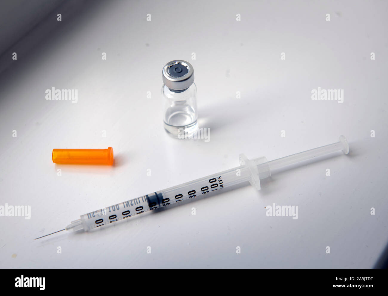 Detail of syringe and bottled tanning product Stock Photo