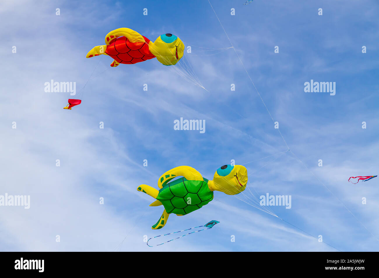Colorful flying 3 D Kites in the blue sky Stock Photo