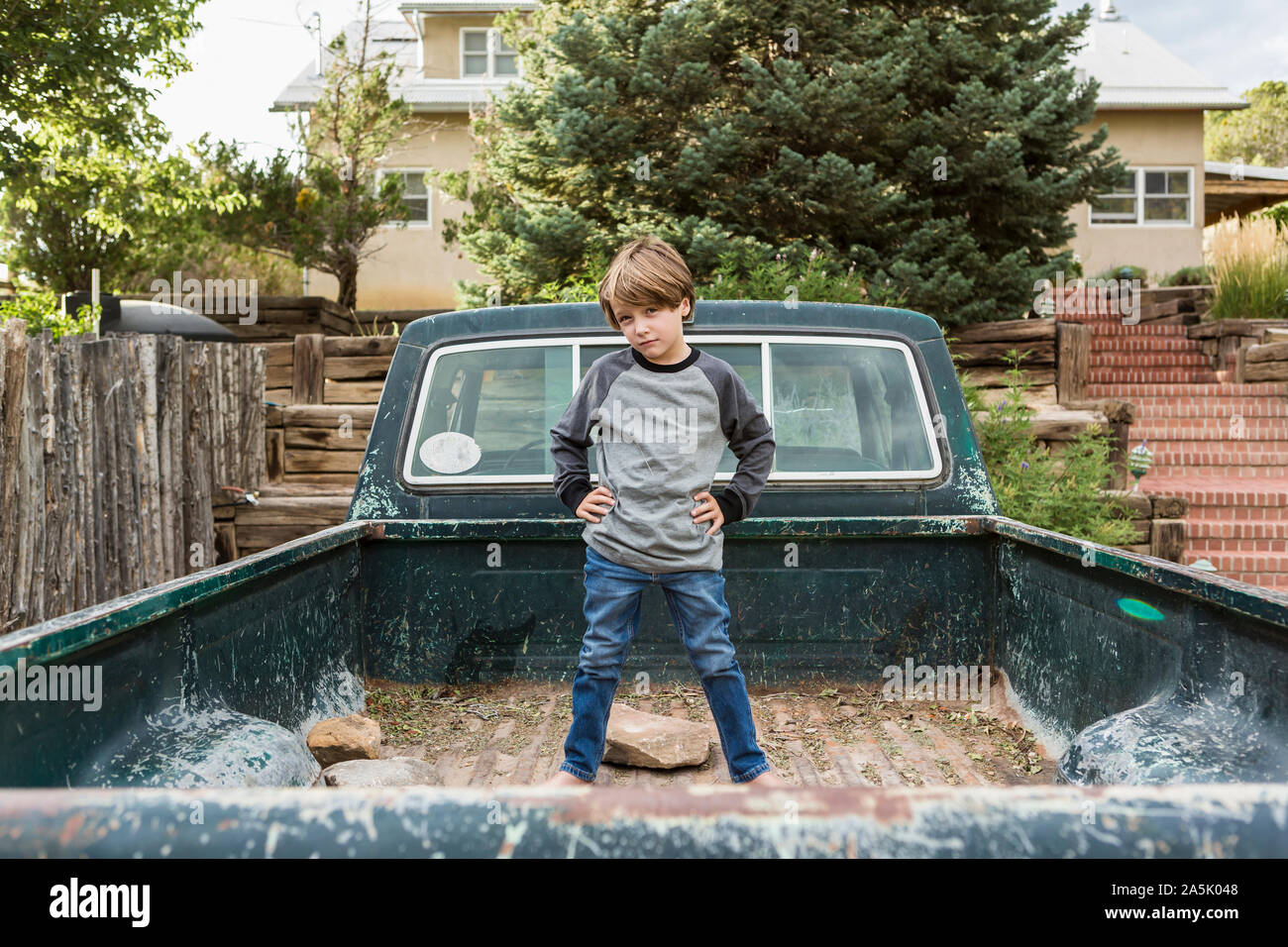portrait of 6 year old boy posing in the bed of an old pick up truck Stock Photo