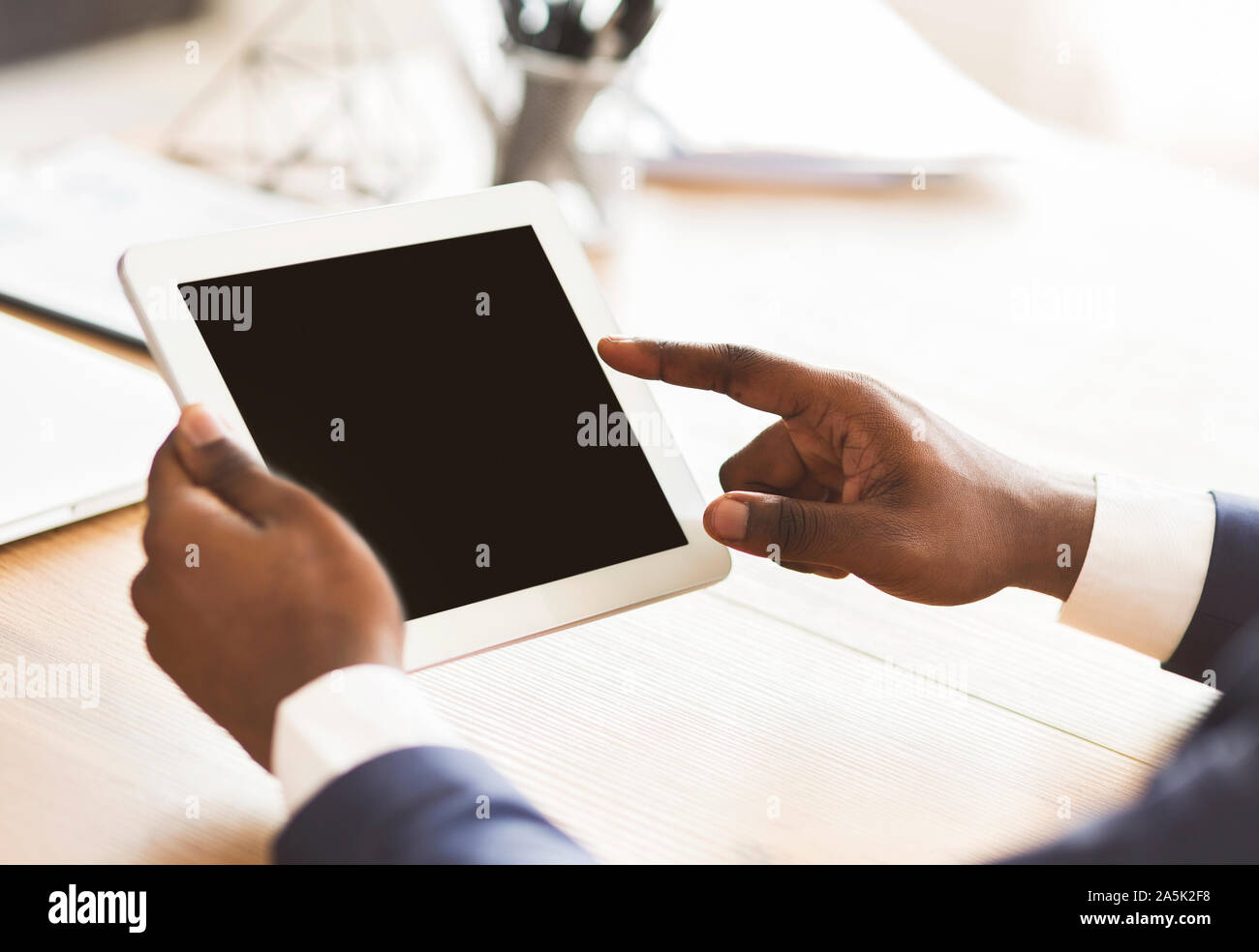 Black man using digital tablet with blank screen Stock Photo