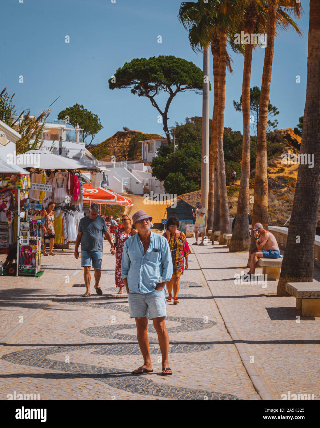 Olhos D'Agua, Portugal - October 3 2019: The promenade of Olhos D'Agua starting to get busy on a warm late summer morning Stock Photo