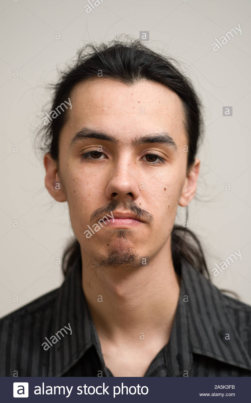 Long Haired Man With A Mustache And Ponytail Wearing A Black